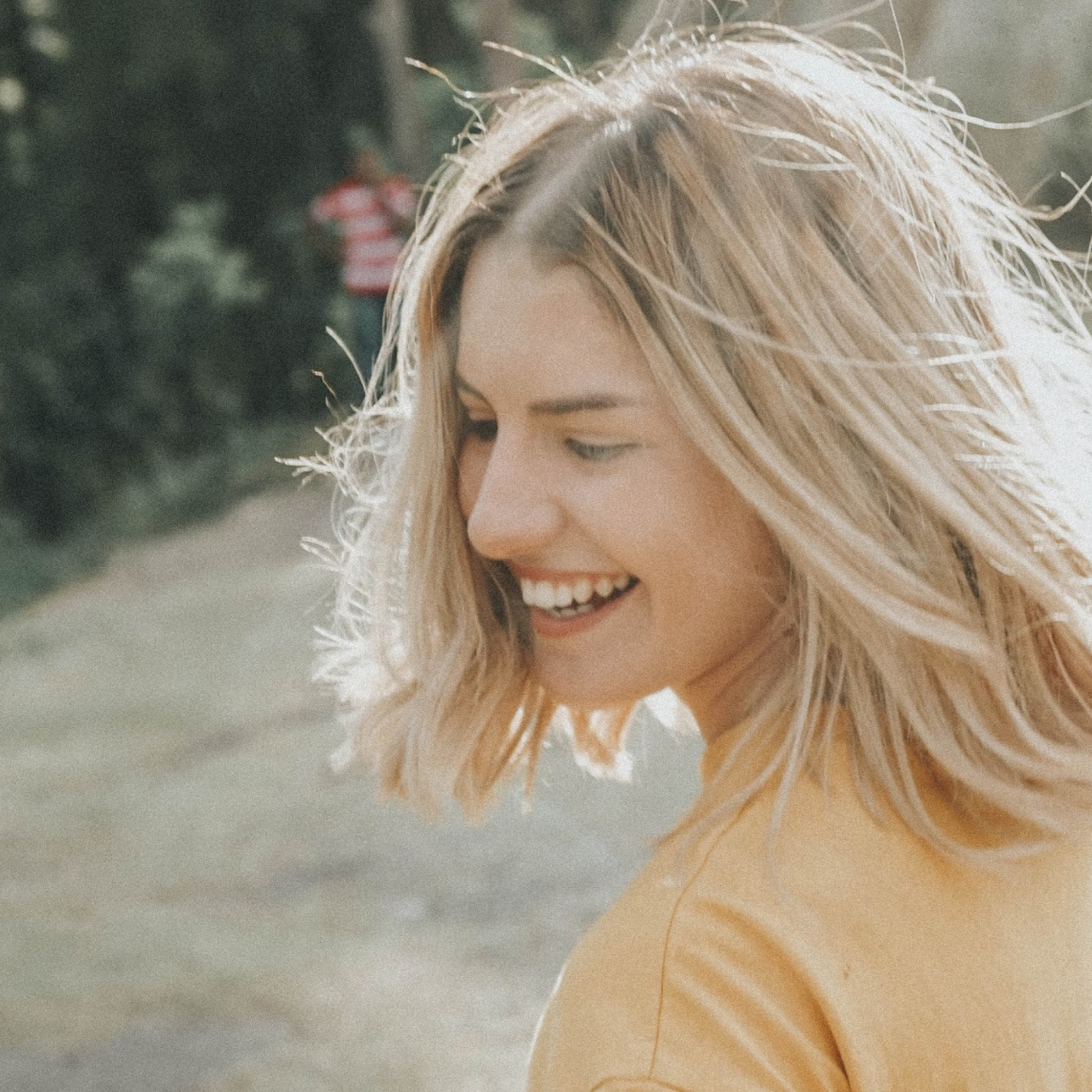 Photo of a Woman Smiling, by Gian Cescon, Unsplash